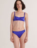 A model in the araks silk gita underwire bra and grier thong in tanzanite blue