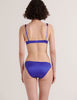 A model from the back in the araks silk gita underwire bra and gwyneth panty in tanzanite blue