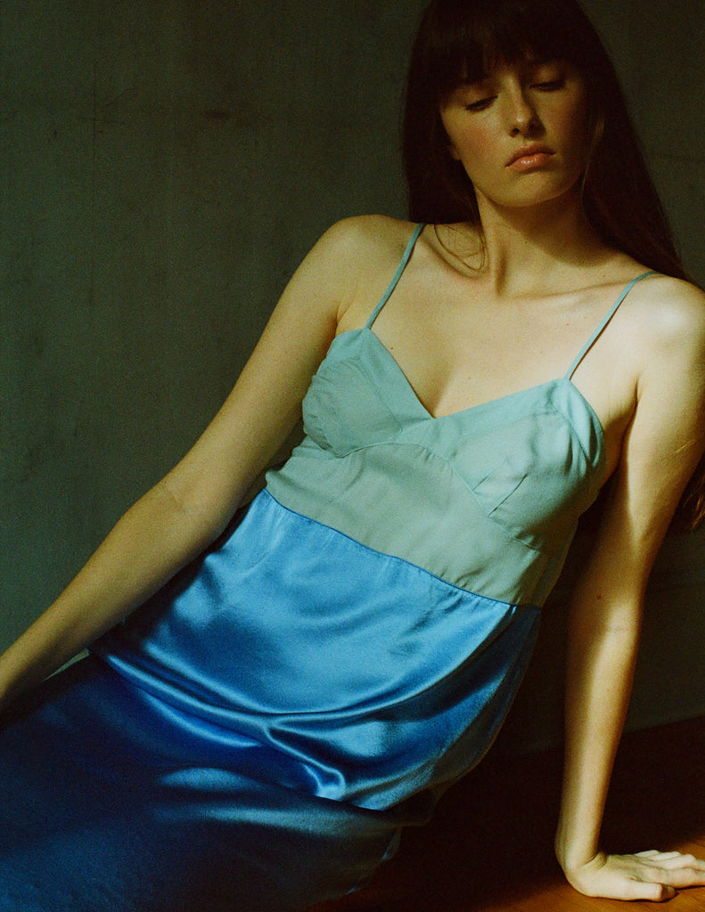 A model posing in a blue and green two toned Araks Ingrid slip.