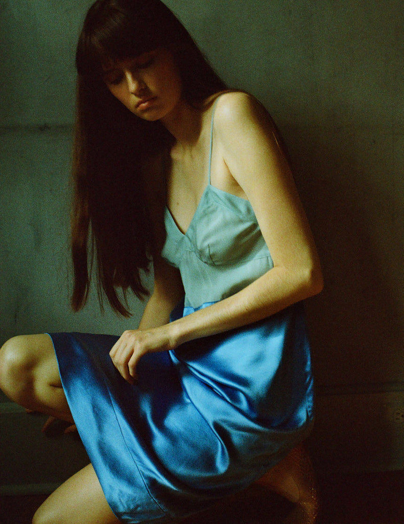 A model posing in a blue and green two toned Araks Ingrid slip.