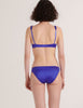 A model in the araks silk penelope bralette and gwyneth panty in tanzanite blue