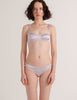 a model in the araks silk penelope bralette and gwyneth panty in fairy lavender purple