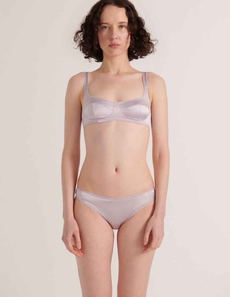 a model in the araks silk penelope bralette and gwyneth panty in fairy lavender purple