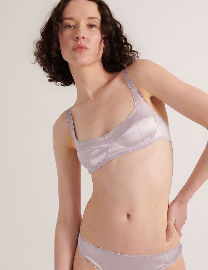 A model in the araks silk penelope bralette and gwyneth panty in fairy lavender purple