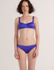 A model in the araks silk penelope bralette and gwyneth panty in tanzanite blue