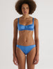 A model in the araks silk charmeuse penelope bralette and gwyneth panty in bluet blue
