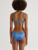 A model in the araks silk charmeuse penelope bralette and gwyneth panty in bluet blue