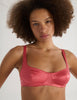 A model in the araks silk penelope bralette in rose pink