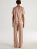 A model in the araks shelby pajama top and ally pajama pant in shiny silk charmeuse