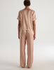 A back view of the shelby pajama top and viktoria pajama bottom in beige silk charmeuse.