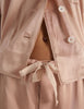 A close up of shiny silk charmeuse araks ally pajama pant and shelby pajama top