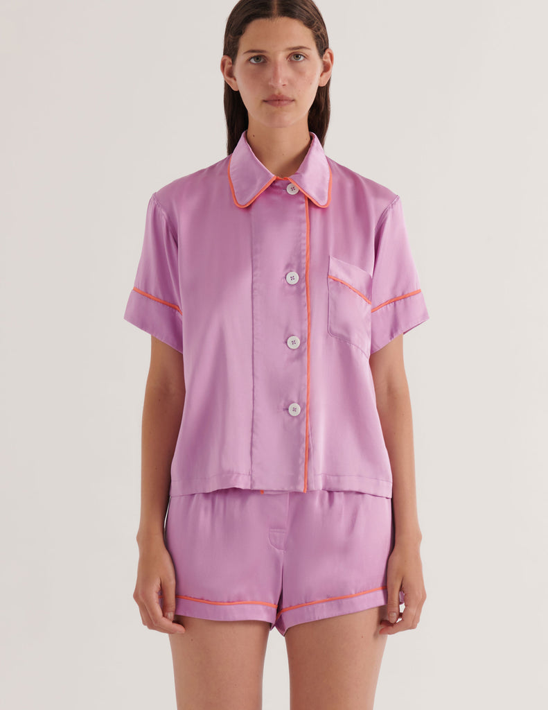 Person wearing a mauve with orange trim Araks Shelby Pajama top and matching Tia Boxer on a white background