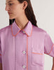 Person wearing a mauve with orange trim Araks Shelby Pajama top on a white background