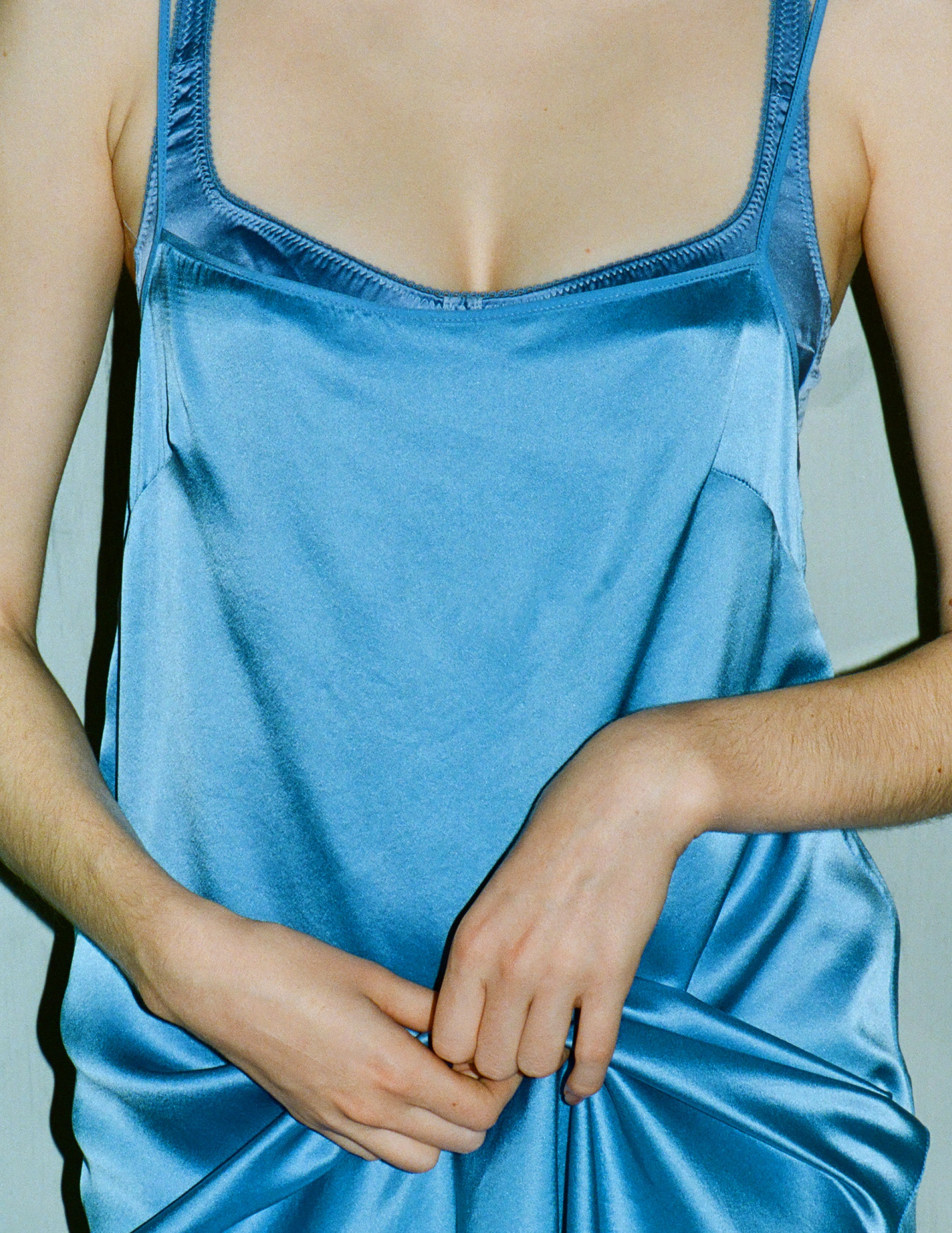 A model wearing a blue silk slip from Araks.