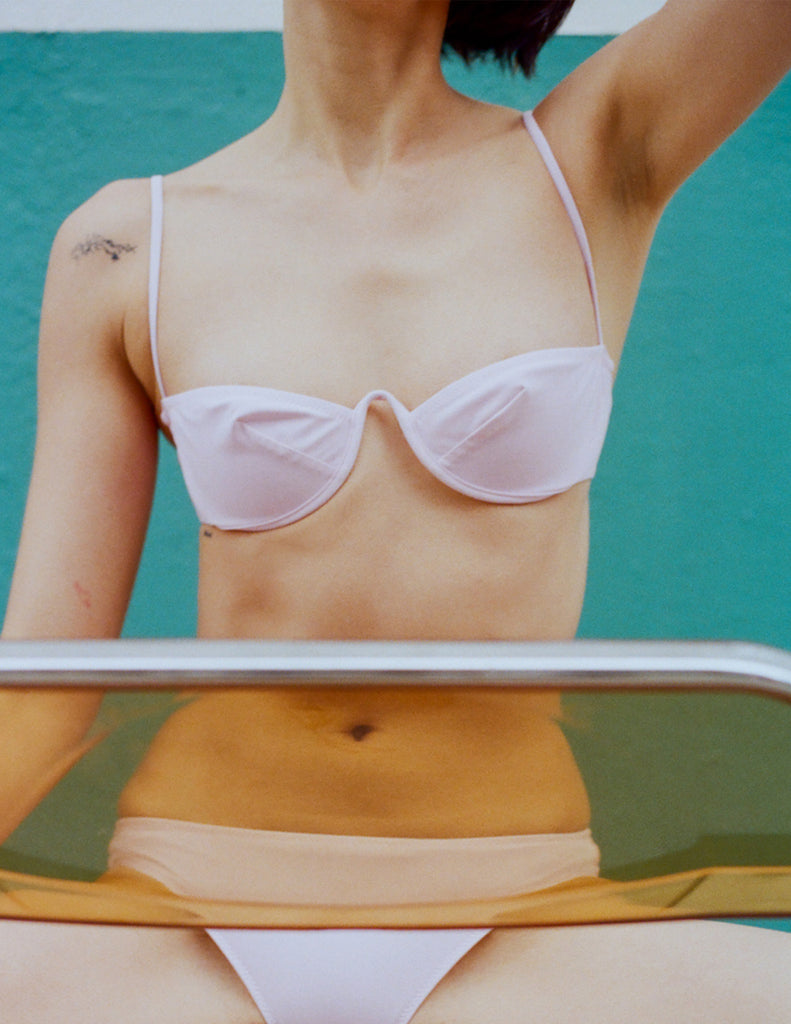 A model in the araks ovsanna bikini top and piper bikini bottom in ballet pink