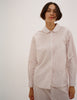 A model in the araks cotton suki pajama top and teagen pajama pant in stripe 