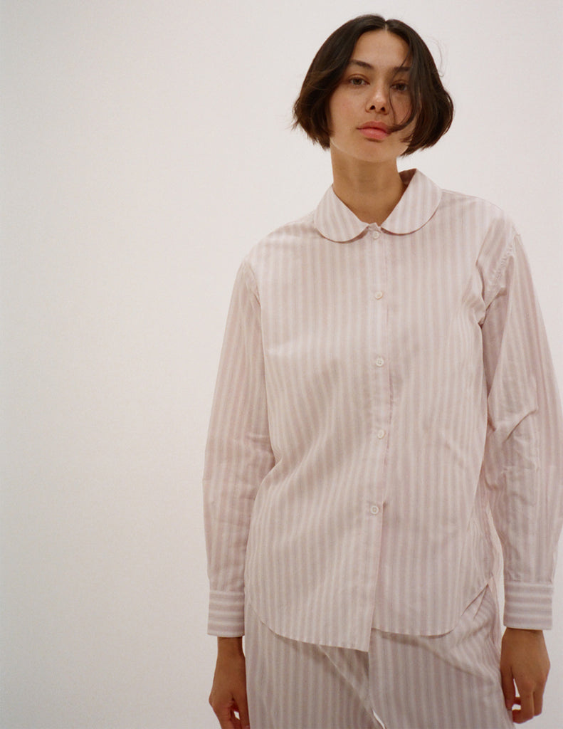 A model in the araks cotton suki pajama top and teagen pajama pant in stripe 