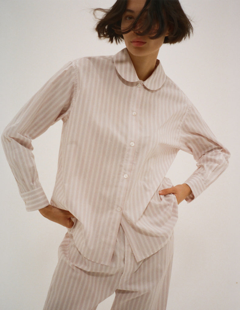 A model in the araks cotton suki pajama top and teagen pajama pant in stripe 