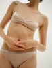 A model in the araks silk quintana bralette and quincy panty in bare
