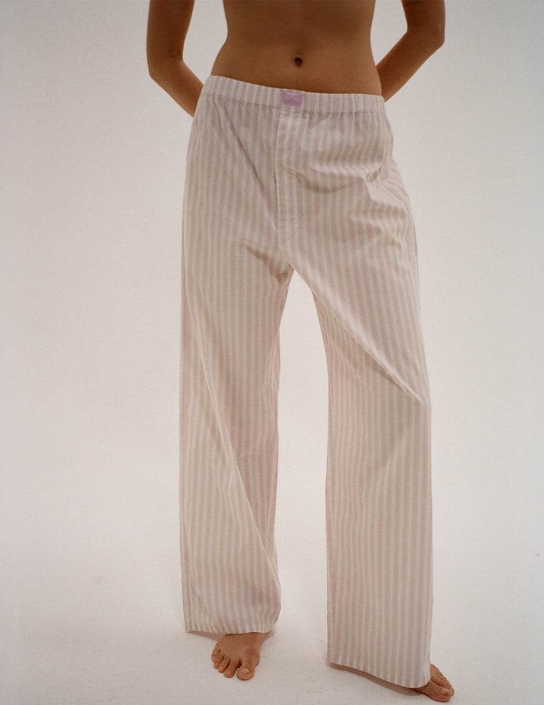 A model in the araks teagen pajama pant in tart stripe 