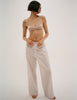 A model in the araks Quintana bralette in bare and teagen pajama pant in tart stripe 