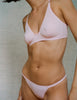 A model in the araks recycled cotton bisoux panty in confection pink