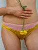 A model in the araks silk beatrice bralette and aaron panty in pomelo yellow