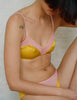 A model in the araks silk beatrice bralette and aaron panty in pomelo yellow