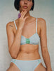 Model wearing Araks Uma bralette and Harriet panty in Verona