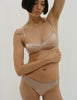 A model in the araks silk quintana bralette and quincy panty in bare