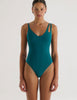 A model in the araks jamie one piece in fern green
