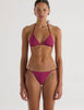 A model in the araks nelle bikini top and nadia bikini bottom in cerise red