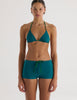 A model in the araks nelle bikini top and polly short in fern green