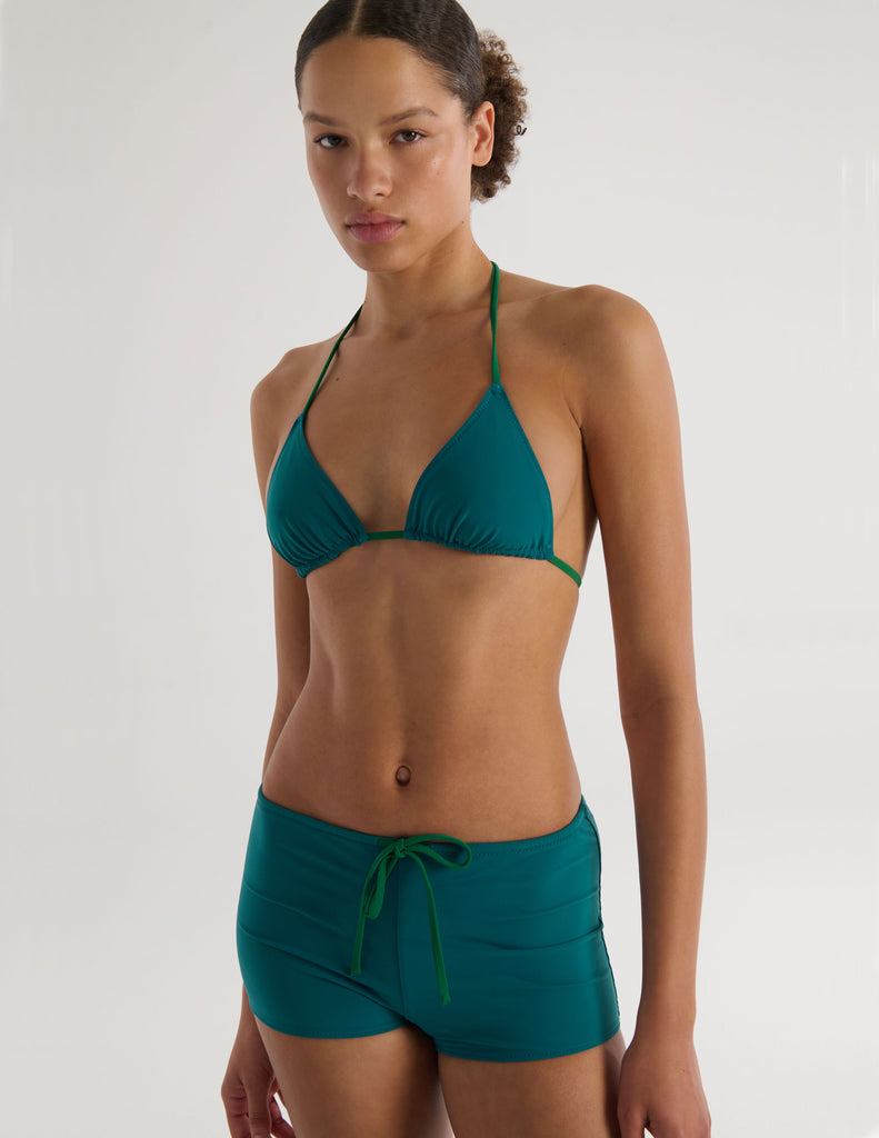 A model in the araks nelle bikini top and polly short in fern green