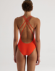 A model in the araks tallulah one piece in papaya orange
