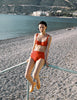 Model wearing Araks Ulija bikini top and Mallory bikini bottom in scarlet