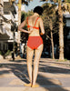 Model wearing Araks Ulija bikini top and Mallory bikini bottom in scarlet