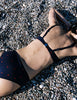 Model wearing Araks Ulija bikini top and Ezra bikini bottoms in navy with red polka dots
