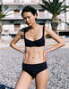 Model wearing Araks Ulija bikini top and Ezra bikini bottoms in navy with red polka dots