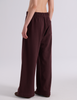 A model shown from the back wearing the Araks Vero wide-leg sweatpants in the shade Mill color, against a light gray studio background.