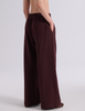 A model shown from the back wearing the Araks Vero wide-leg sweatpants in the shade Mill color, against a light gray studio background.