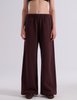 A model shown from the back wearing the Araks Vero wide-leg sweatpants in the shade Mill color, against a light gray studio background.