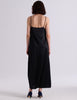 A woman modeling the Araks Vika slip in Black against a light gray studio background.