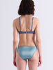 Model wearing Araks Willow bralette in Aegean blue in front of a off white background