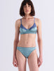 Model wearing Araks Willow bralette in Aegean blue in front of a off white background