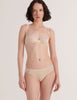 Woman wearing a Araks Cream cotton Chloe bra with lavendar lace trim