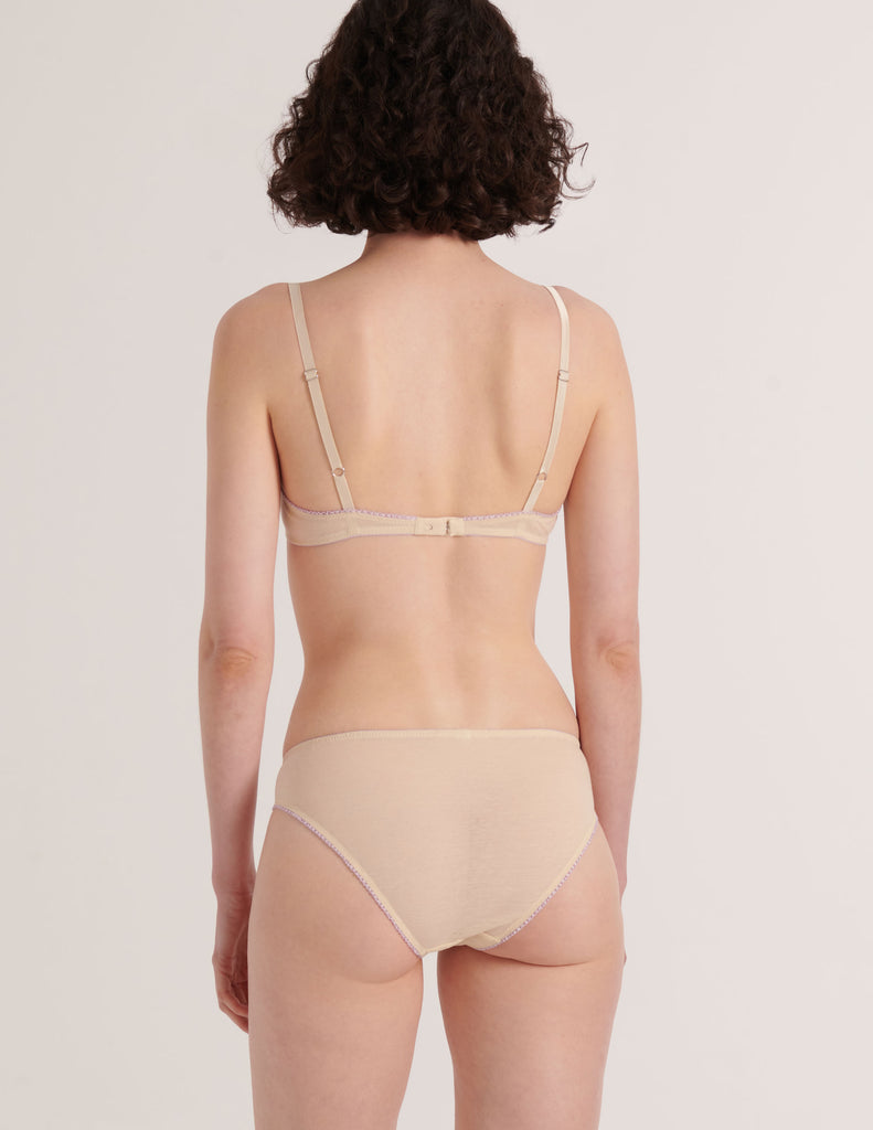 back of Woman wearing a Araks Cream cotton Chloe bra with lavendar lace trim