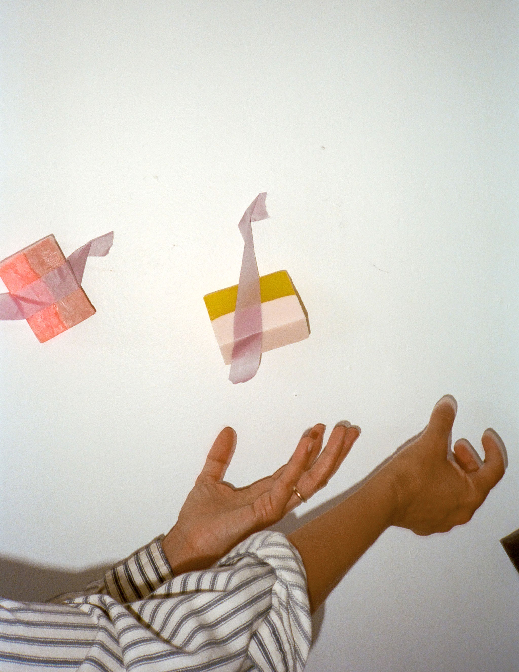 person catching Araks handmade soap falling