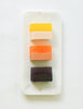 Three colorful Arask handmade soap bars on a white marble dish
