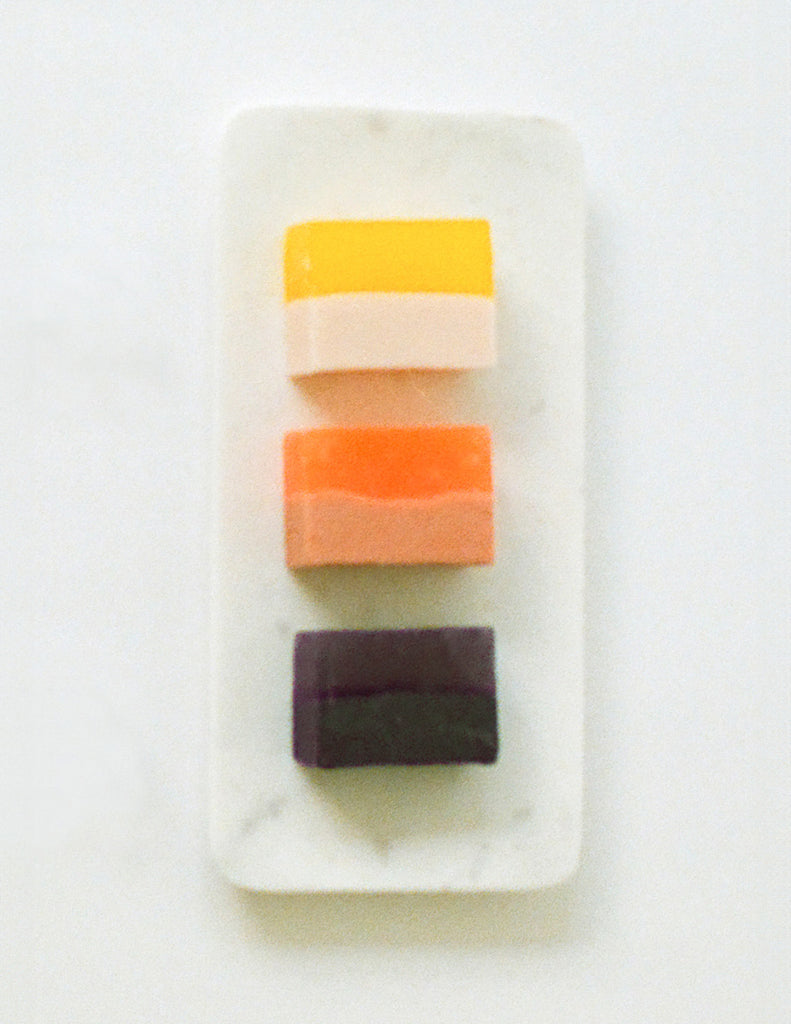 Three colorful Arask handmade soap bars on a white marble dish
